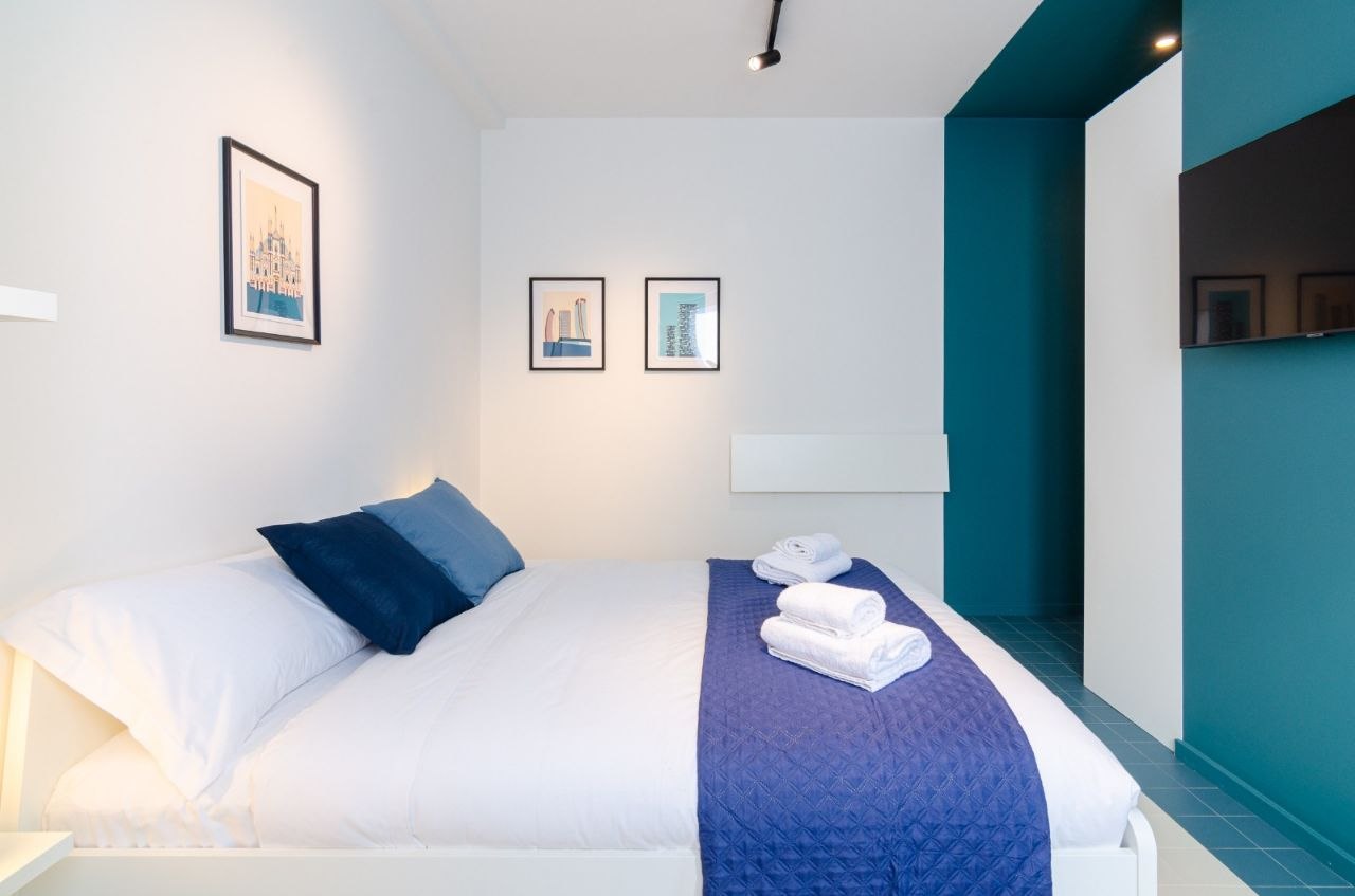 Bedroom with Milan-themed artwork