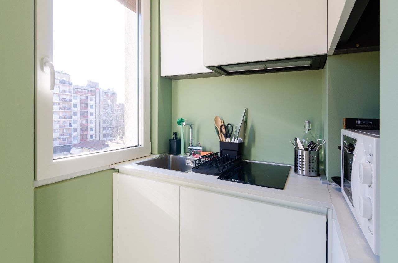 Kitchen and living area with mint green accents